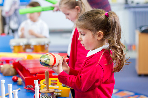 Children laying with colored tools & toys sensory rooms