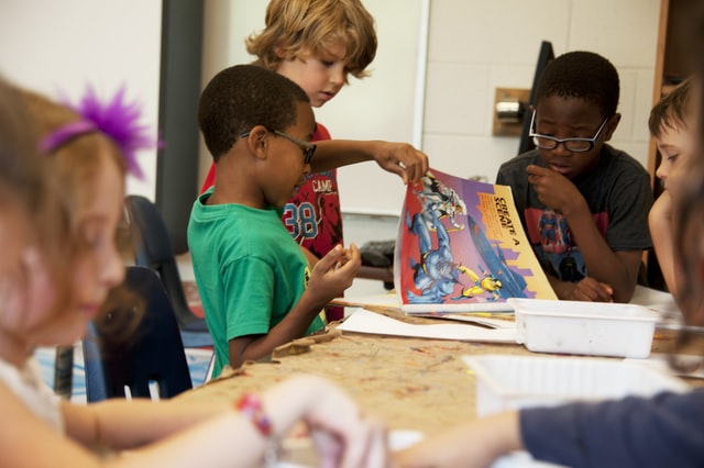 Children reading book together on First Day of School