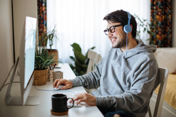 Young men playing video games with desktop