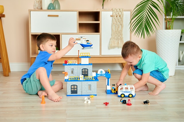 Two boys playing toys team building activities for kids
