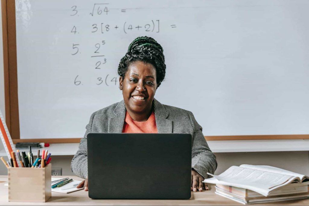 teachersmiling Image of a teacher looking at a laptop