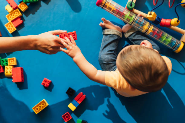 Baby playing with toy blocks teaching preschoolers