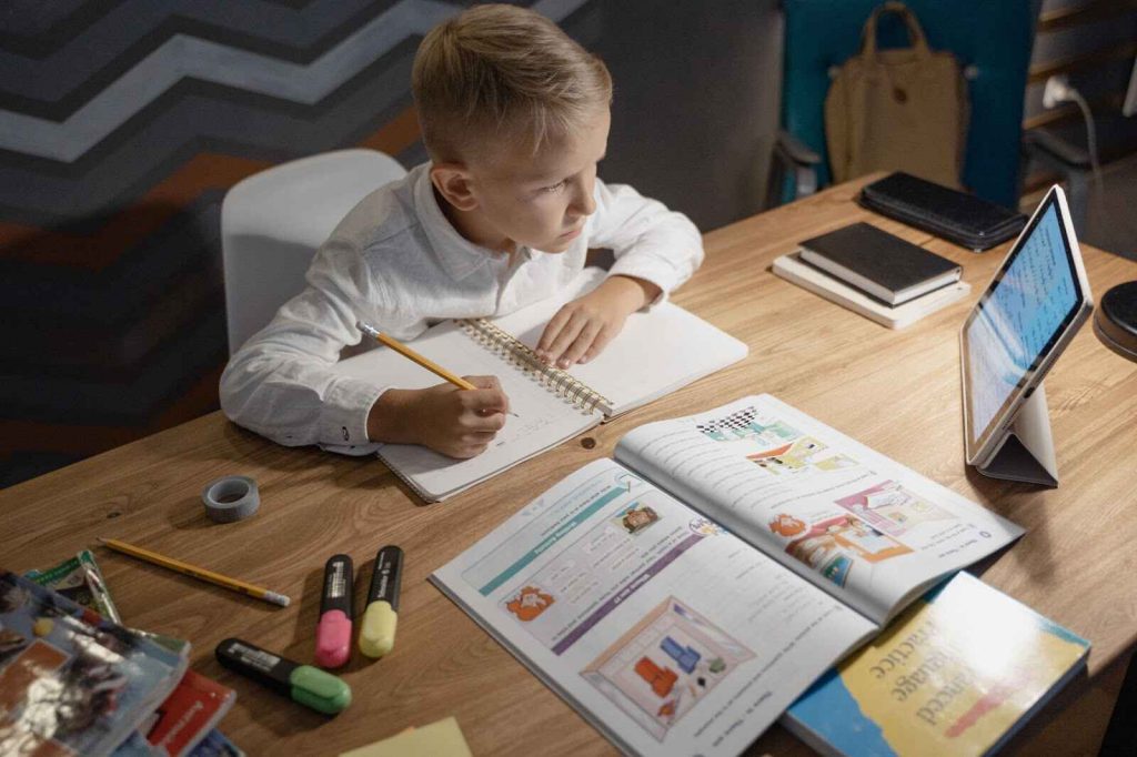 Boy reading and writing zones of learning Boy reading and writing zones of learning