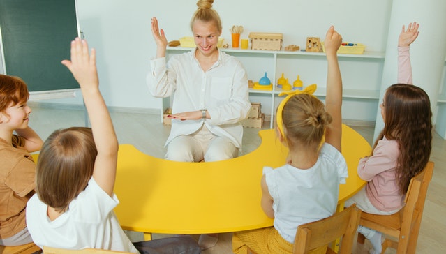 Children raising their hands What is taught to kids in 2nd grade