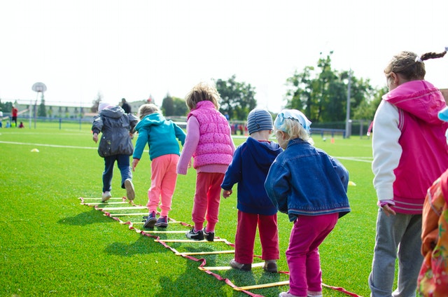 Childrens team building on green grassland zones of learning Children's team building on green grassland zones of learning