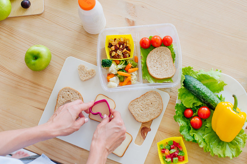 Closeup of hands preparing sandwich for lunch box lunch ideas for kids Closeup of hands preparing sandwich for lunch box lunch ideas for kids