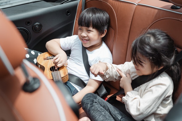 Happy kids traveling in car playing car games for kids