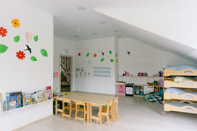 Kids playroom with wooden tables and bunk bed Classroom Organization Ideas