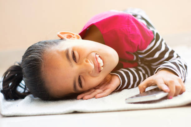 Little girl playing on phone Toys for Autistic Kids Little girl playing on phone Toys for Autistic Kids