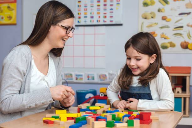 Beautiful mother and daughter spending time together teaching preschoolers