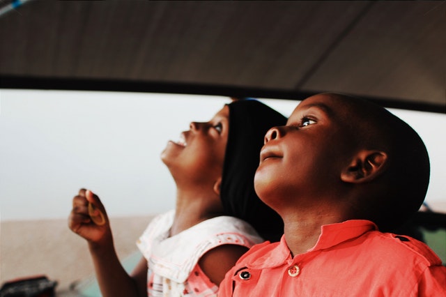 Two children looking up inside a car games for kids