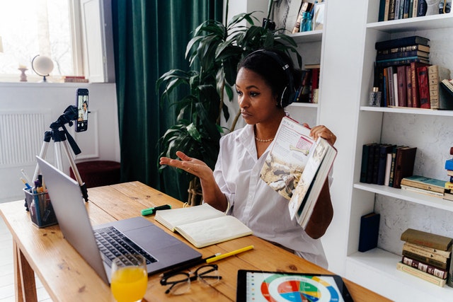 Woman sitting in front of laptop teaching online zones of learning Woman sitting in front of laptop teaching online zones of learning