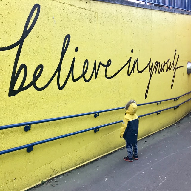 child looking at inspirational quote on wall kids positive affirmations