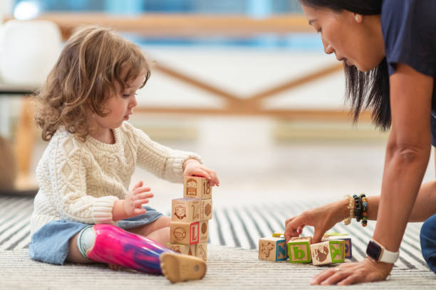 Image of a special kid building blocks with mom
