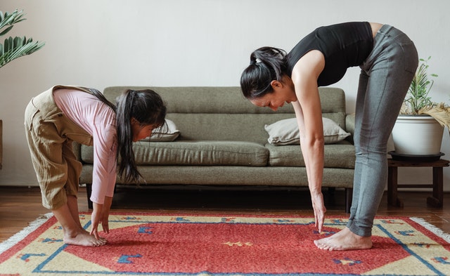 Image of a kid and parent doing Yoga together 