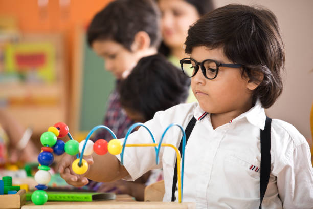 Little boy learning with abacus at preschool Little boy learning with abacus