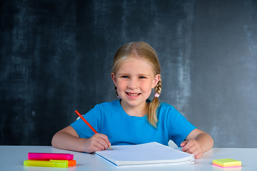 A girl smiling while writing