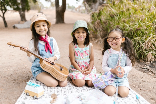 little girls playing on picnic summer camp kids