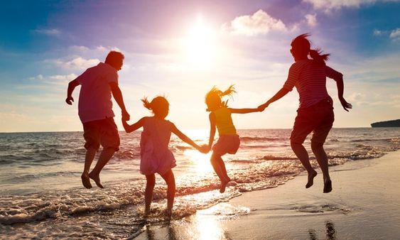 Image of a family having fun at the beach 