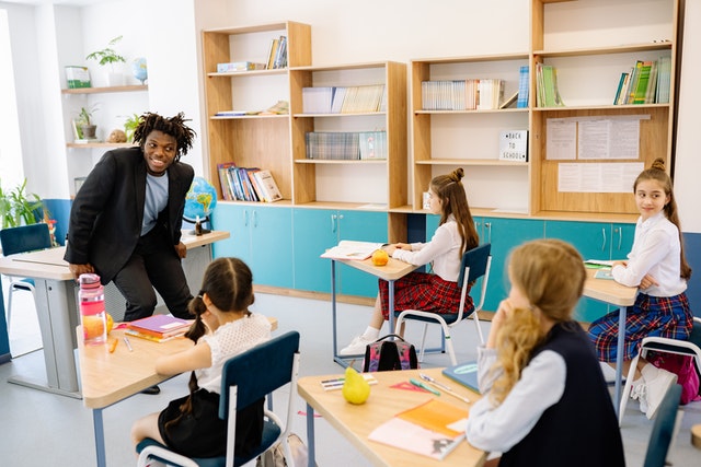 Man teaching children at a class Healthy student centered learning environment