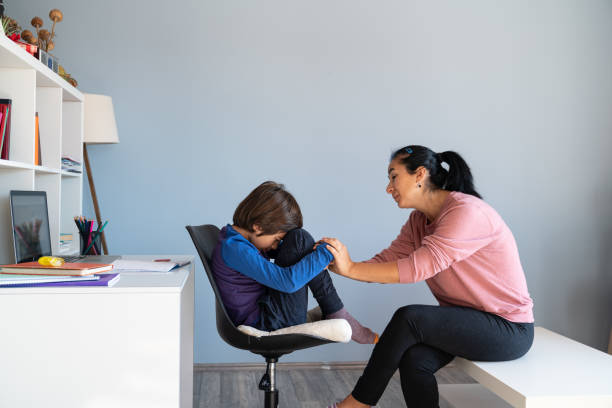 Mother talking to bored schoolboy child struggling in school Mother talking to bored schoolboy child struggling in school
