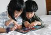 Children playing games on tablet