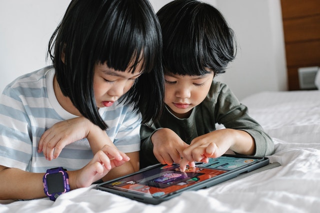 Children playing games on tablet