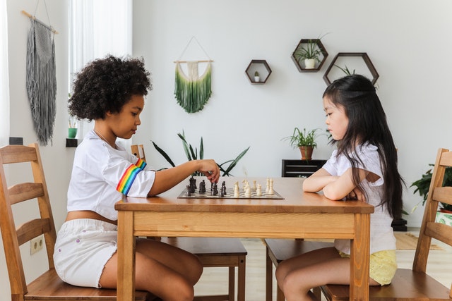 Girls sitting playing chess
