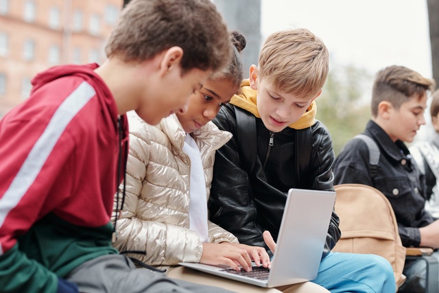 Kids using a laptop to study