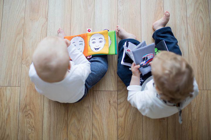 Two small children playing on the floor