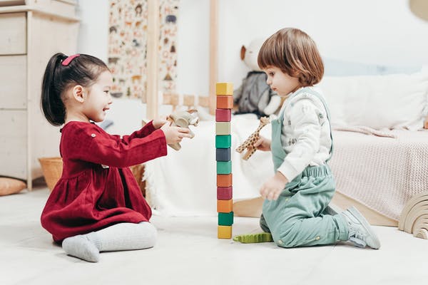 two small children playing with block