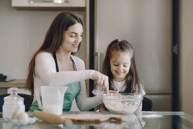 Mather and daughter baking together