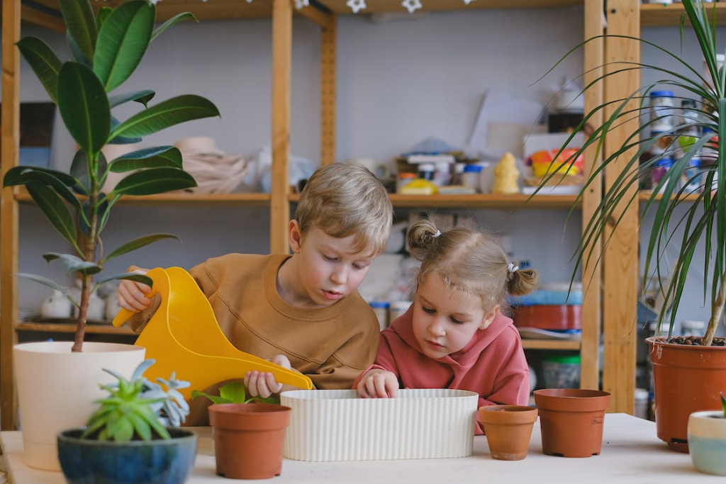 Boy and girl pouring water in a pot