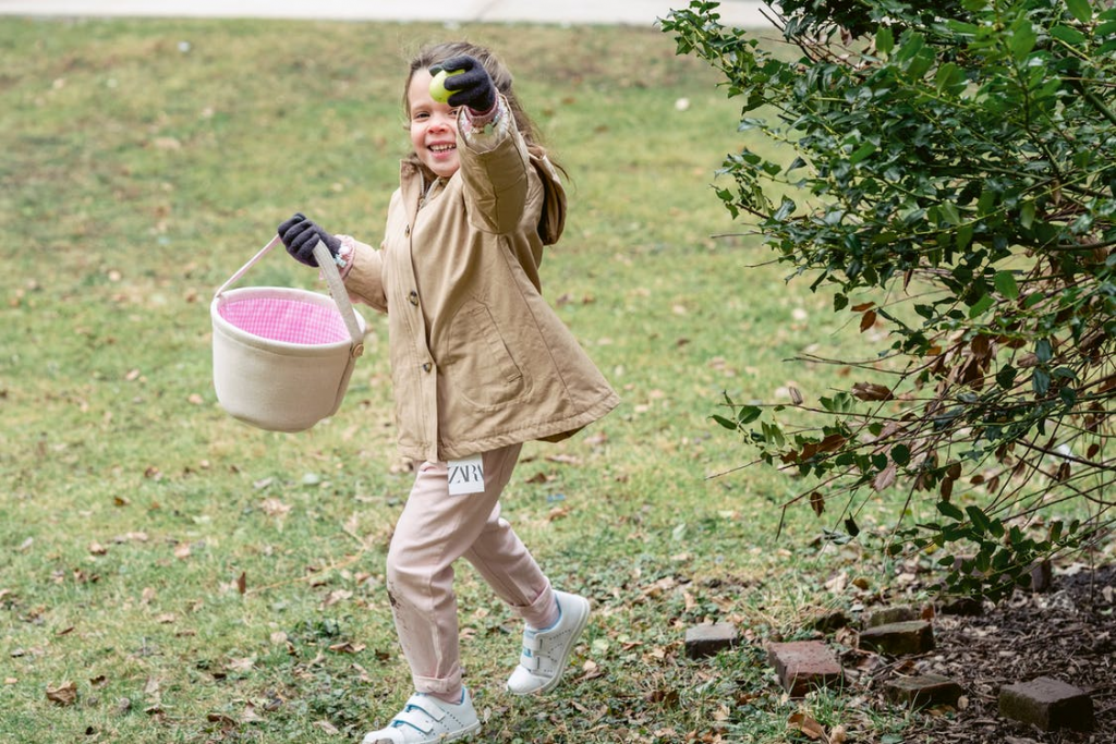 Small girl running with fruit in hand