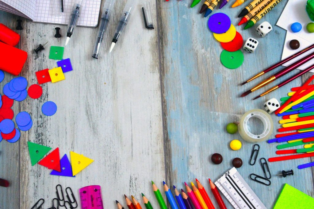 Classroom supplies strewn on a desk for the first day of kindergarten