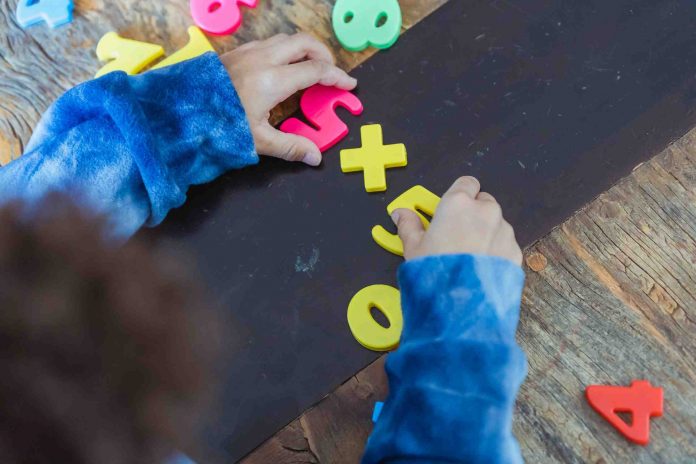 A child’s hands playing with number toys