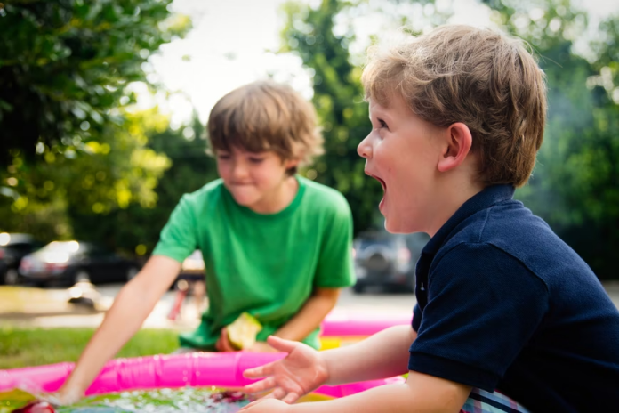 Young kids playing with pipes and laughing