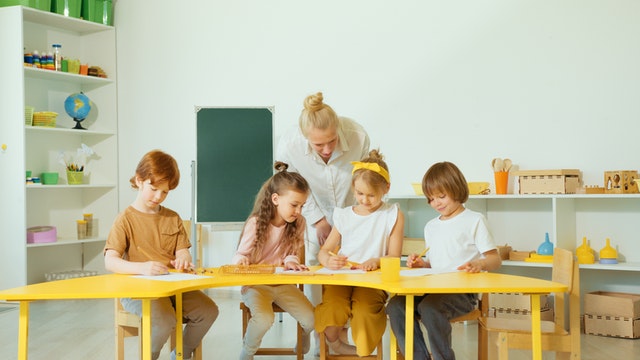 Woman checking the kids writing