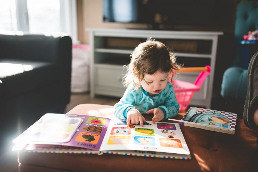 Young child reading a large picture book