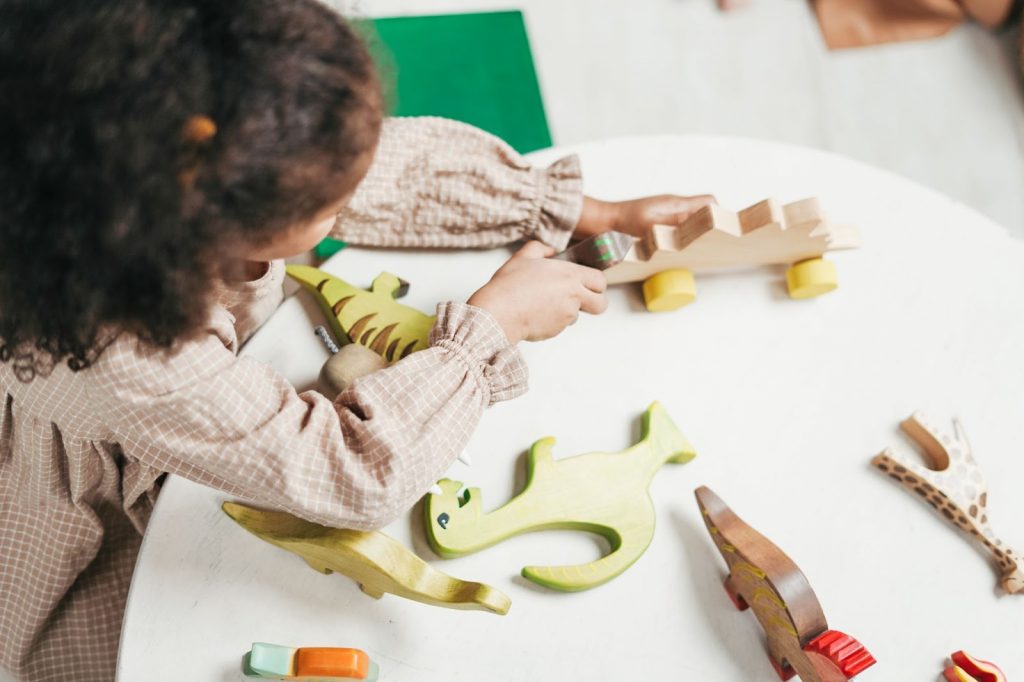 Young child playing with wooden toys