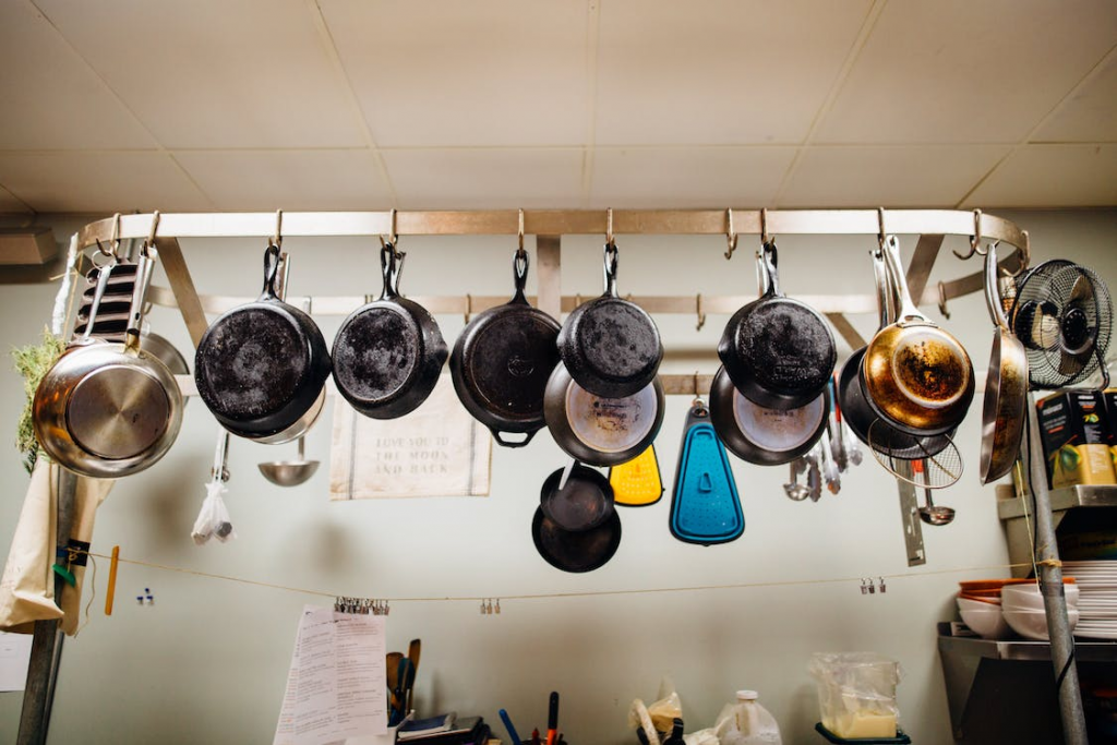 Different utensils hanging in pot rack