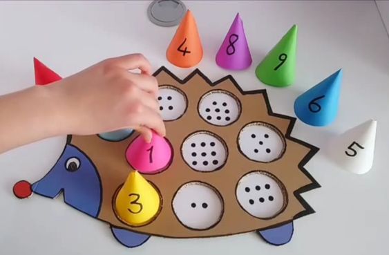 A board game with a cardboard hedgehog and paper cones