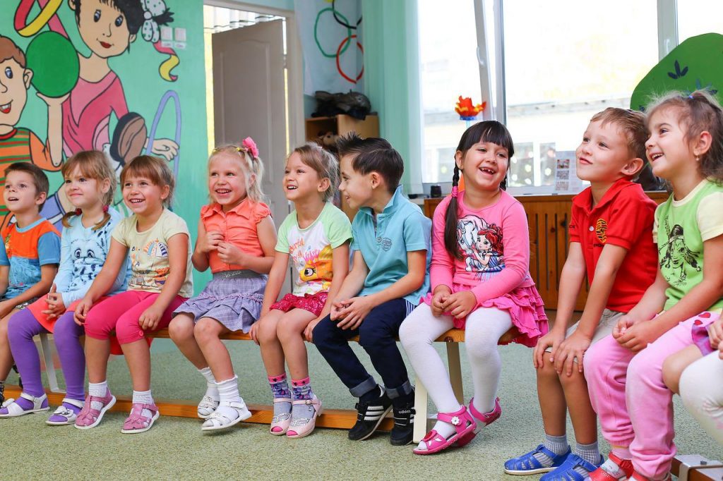 A group of laughing kids sitting in a row