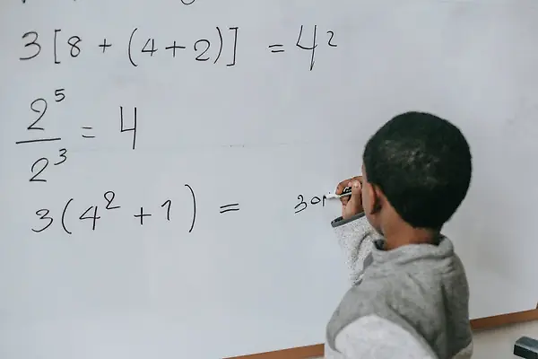 vedicmathtrickskidswontbelieve Boy writing math solutions on a whiteboard