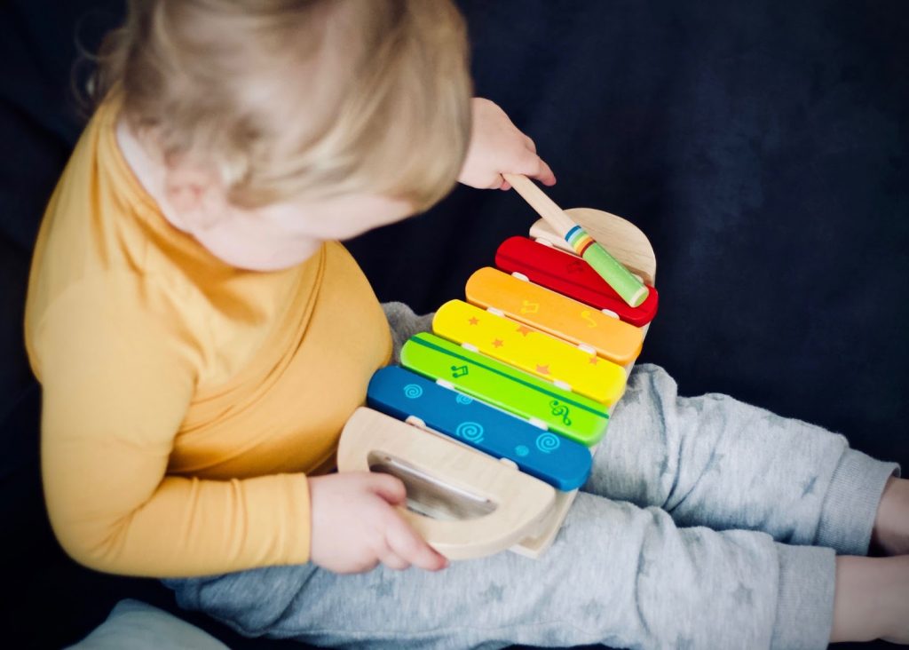 Young kid playing with xylophone