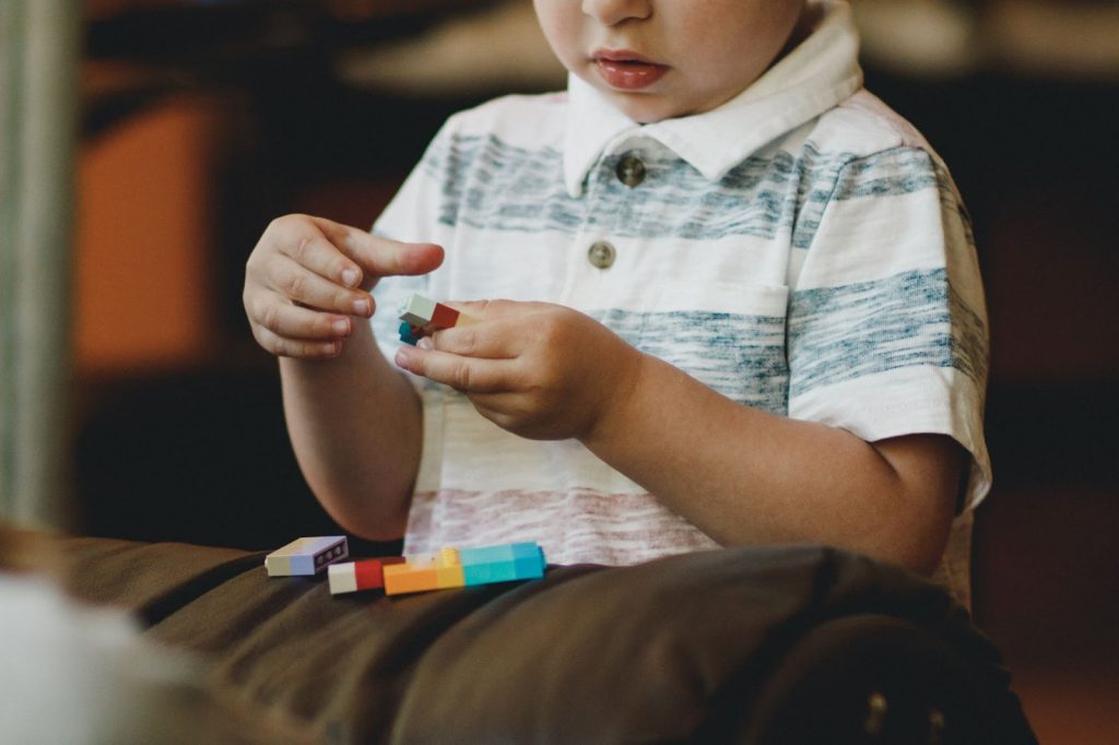 Small child playing with lego blocks