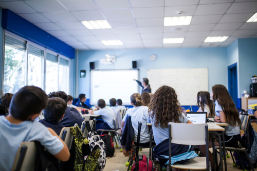 Children in school uniform sitting in a classroom