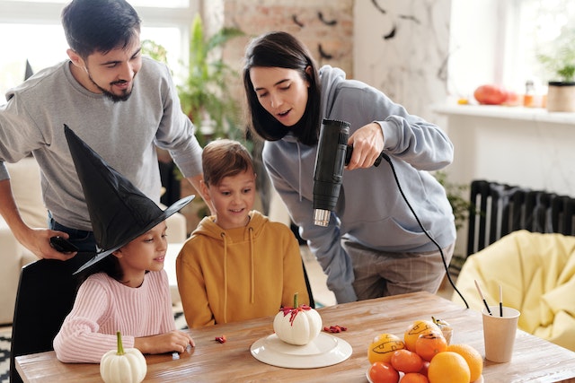 Family making Halloween crafts for kids