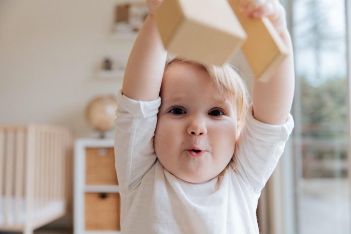 Baby playing with wooden blocks