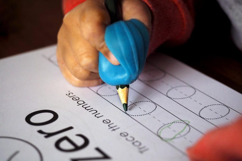 A hand tracing the shape of zero